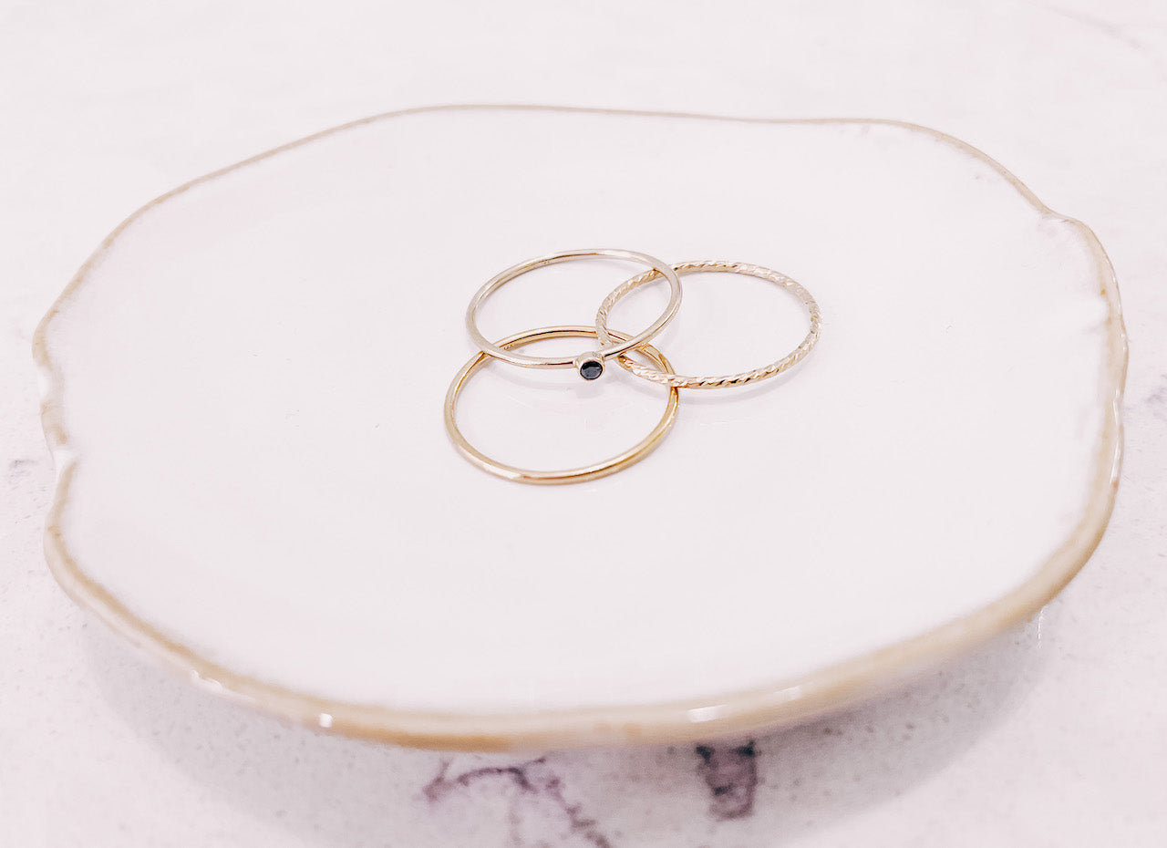 3 Stacker rings laying on a jewellery trinket dish by lady startup Australian jewellery label, AW Boutique.