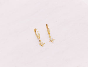 Mini north star shaped charm hanging from gold filled huggie earrings.  Celestial jewellery.