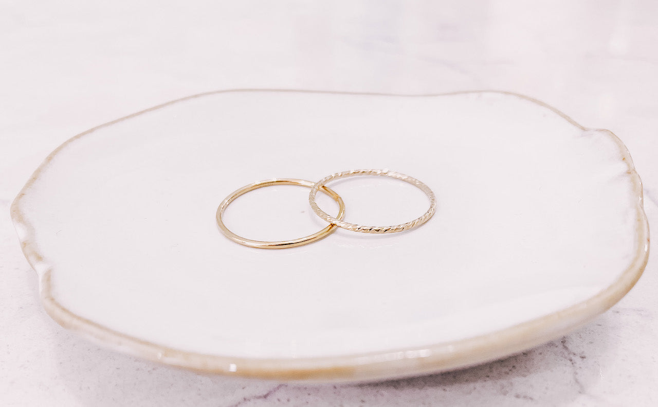 Sparkle stacker & Plain stacker rings laying on trinket dish by lady startup Australian jewellery label, AW Boutique.