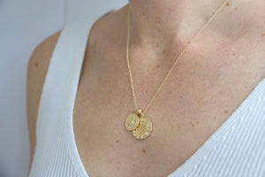 Model wearing gold filled zodiac star sign coin charm necklace. Australian jewellery brand AW Boutique. Part of the Celestial Collection. Necklace option shown is Taurus.
