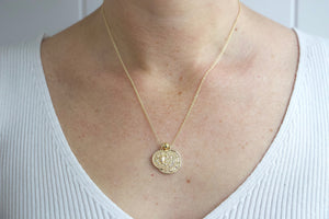 Model wearing gold filled zodiac star sign coin charm necklace. Australian jewellery brand AW Boutique. Part of the Celestial Collection. Necklace option shown is Taurus.