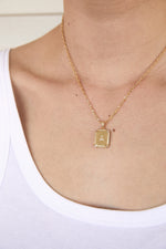 Load image into Gallery viewer, Model wearing AW Boutique&#39;s gold filled 16 inch cable chain necklace finished with a dainty initial pendant with cubic zirconia detail. Initial A is shown.
