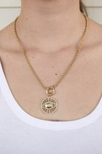 Load image into Gallery viewer, Model wearing gold filled evil eye medallion pendant charm necklace. This is a bold gold necklace design. Australian jewellery brand AW Boutique.
