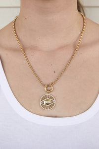 Model wearing gold filled evil eye medallion pendant charm necklace. This is a bold gold necklace design. Australian jewellery brand AW Boutique.