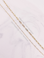 Load image into Gallery viewer, Mini Paperclip Chain Necklace and Paperclip Chain Necklace laying next to each other to compare the size difference of the two links.  AW Boutique gold filled jewellery.
