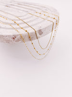 Load image into Gallery viewer, 3 layering chains draped hanging off end of tray from AW Boutique gold filled jewellery.
