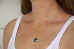Load image into Gallery viewer, Model wearing AW Boutique&#39;s Zodiac Astro Coin is a dainty pendant full of sparkle and shine.  This piece adds a pop of colour to your everyday wear and at 18 inches is a great length to mix and layer your other chains with.  Proudly wear either your own star sign or the star sign of a loved one close to your heart.  Zodiac shown is Taurus.
