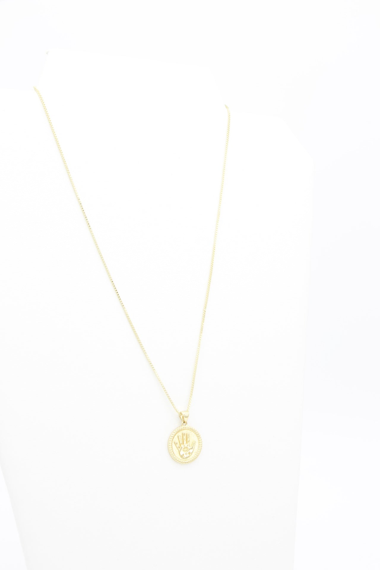 AW Boutique's gold filled 18 inch box chain with a vintage looking Hamsa coin pendant. The Hamsa has small inscriptions and an evil eye on the hand. Pendant has rope effect edging. Part of Protection collection. Gold filled jewellery.