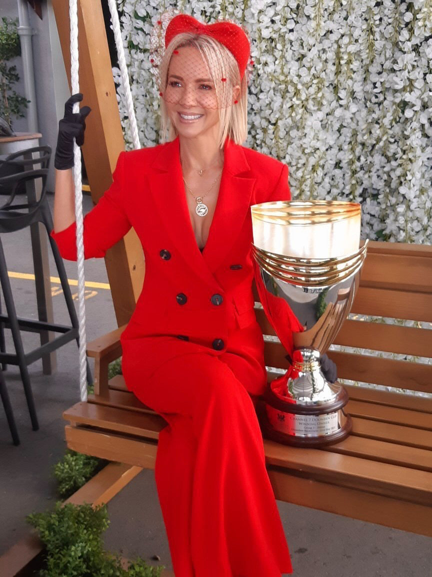 Katrina Blowers from Channel 7 wearing AW Boutique's Evil Eye Rolo Necklace in the Courier Mail photoshoot for the 2021 Doomben Cup Day photoshoot. Gold filled evil eye medallion pendant charm necklace. This is a bold gold necklace design. Australian jewellery brand AW Boutique.
