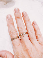 Load image into Gallery viewer, Gold filled stacker rings worn on a hand, creating a ring stack, by lady startup Australian jewellery label, AW Boutique.
