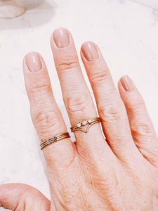 Gold filled stacker rings worn on a hand, creating a ring stack, by lady startup Australian jewellery label, AW Boutique.