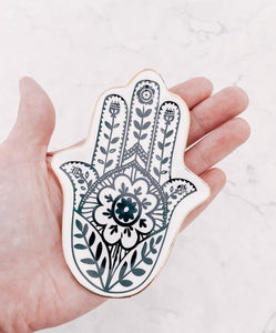 Hamsa Hand jewellery trinket tray from Australian jewellery brand AW Boutique.  Pictured sitting in the palm of a hand to show size.