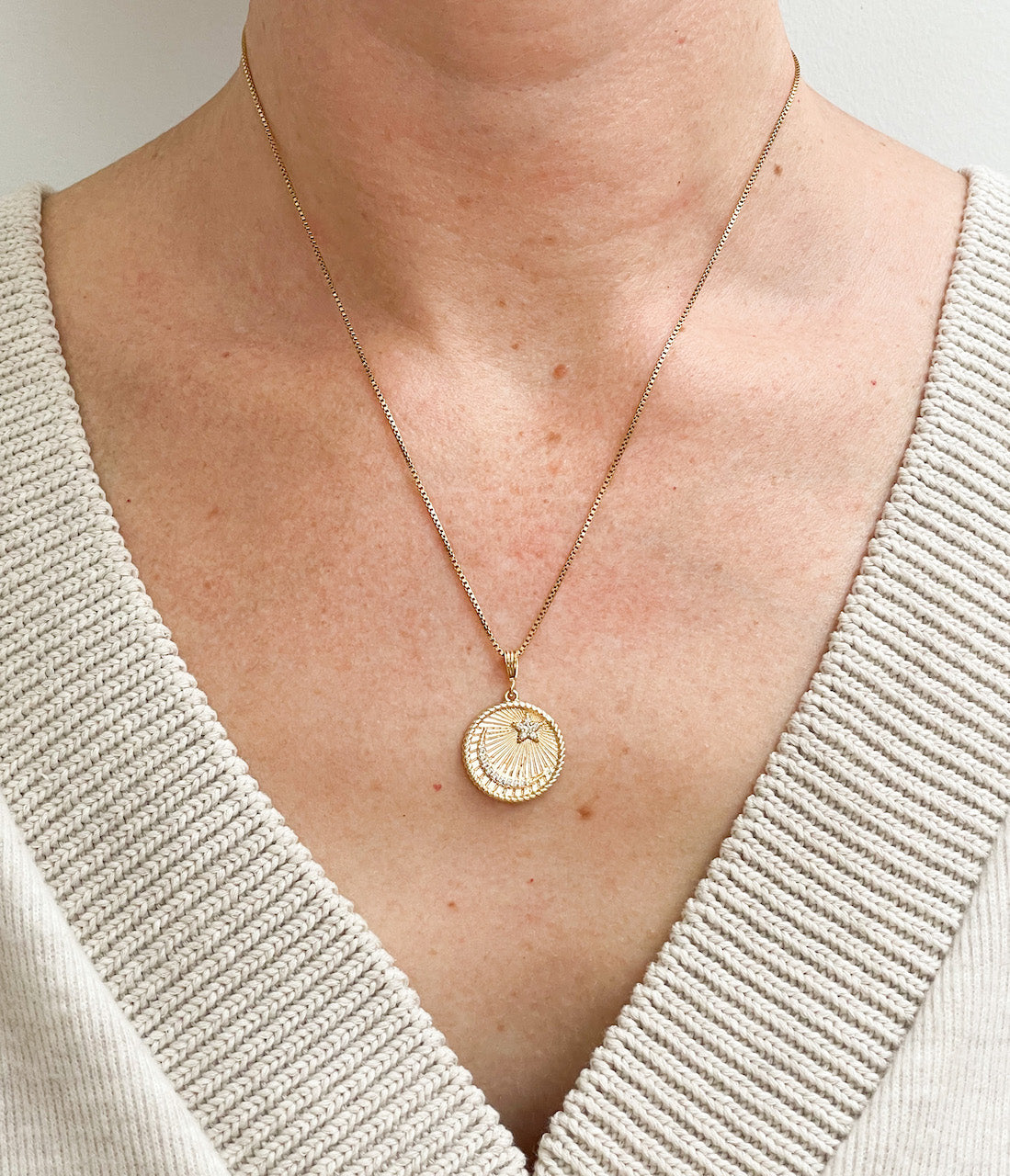 Celestial Coin pendant on a gold filled box chain necklace. Pendant has a crescent moon and star.