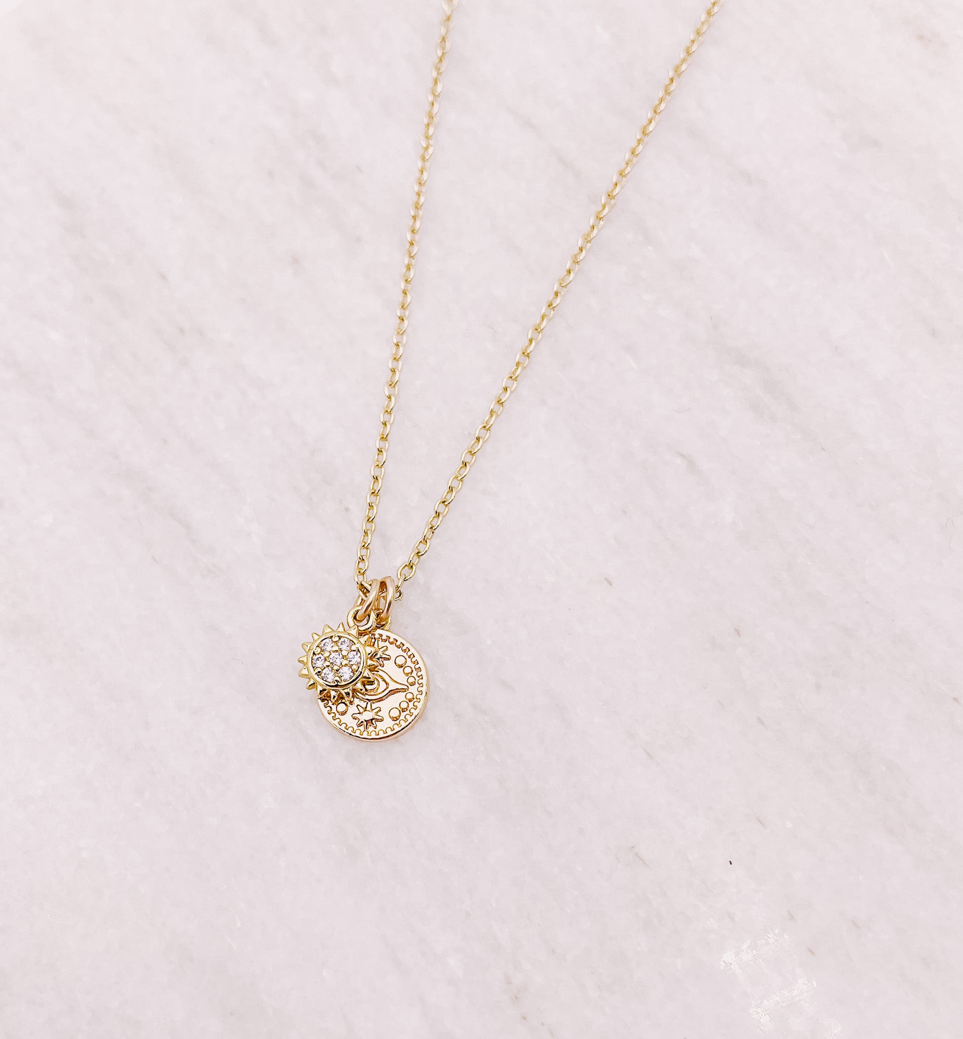 AW Boutique's gold filled 16 inch dainty necklace with a mini Sun and mini Evil Eye Coin charm pendant. Part of Celestial collection. Gold filled jewellery.