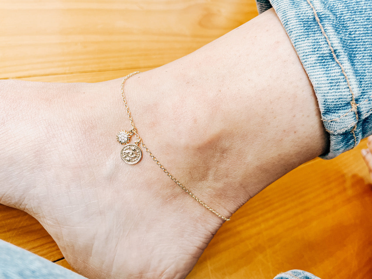 Model wearing AW Boutique's Mini Evil Eye Gold Coin Anklet with optional add on Mini Sun charm.