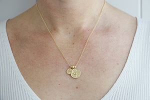 Model wearing AW Boutique's gold filled 18 inch dainty necklace chain with a large Evil Eye coin and a mini Evil Eye coin charm pendant. Part of Protection collection. Gold filled jewellery.