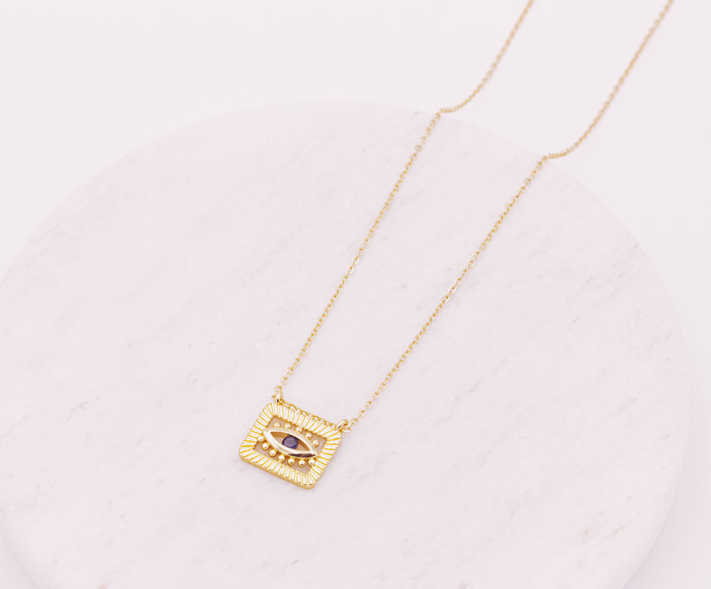 Evil Eye square pendant hanging from a dainty cable link gold filled chain necklace.  Evil Eye is a protective symbol and talisman.  Protection jewellery.