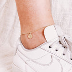 Load image into Gallery viewer, Model wearing AW Boutique&#39;s Mini Evil Eye Gold Coin Anklet.
