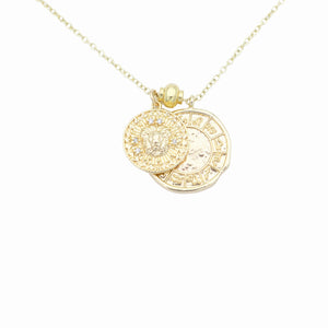 AW Boutique's dual zodiac coin necklace featuring a dainty necklace chain, zodiac rustic coin charm, and your chosen star sign coin charm. Charms separated by a gold bead. Part of the Celestial Collection. Gold filled jewellery. Option shown is Leo.