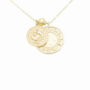 AW Boutique's dual zodiac coin necklace featuring a dainty necklace chain, zodiac rustic coin charm, and your chosen star sign coin charm. Charms separated by a gold bead. Part of the Celestial Collection. Gold filled jewellery. Option shown is Pisces.