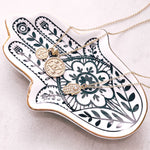 Load image into Gallery viewer, Hamsa Hand jewellery trinket tray from Australian jewellery brand AW Boutique.  Pictured with gold necklaces draped across the tray.

